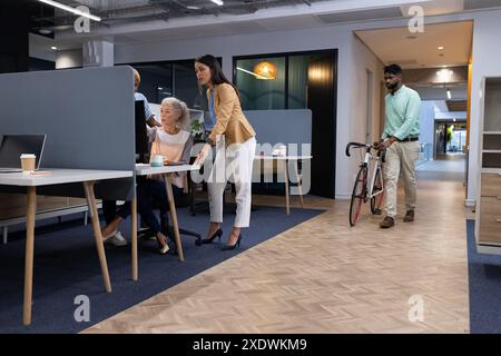 Diverse group of business colleagues collaborating on computer in modern office Stock Photo