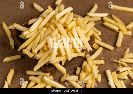 thinly sliced potatoes for baking in oil, frozen potatoes for deep-frying Stock Photo