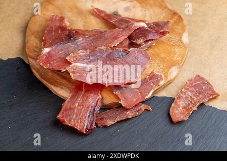 dried pork meat on the table in close-up, dried with salt and spices pork Stock Photo
