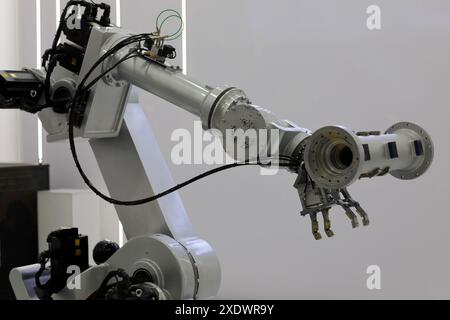 6 axis manufacturing industrial robotic arm with workpiece. Selective focus. Stock Photo