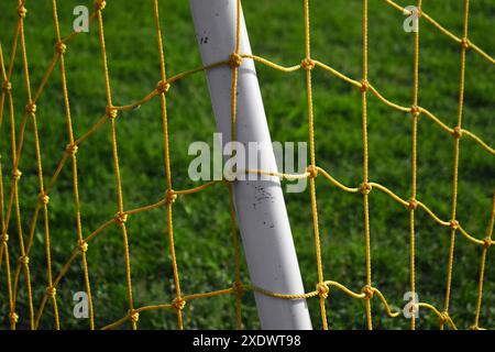 Football goal in the football field in the morning with a sunset background Stock Photo