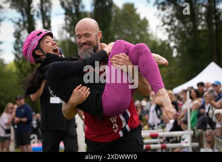 Beijing, Canada. 23rd June, 2024. Competitors take part in a wife-carrying contest in Burnaby, British Columbia, Canada, June 23, 2024. Credit: Liang Sen/Xinhua/Alamy Live News Stock Photo