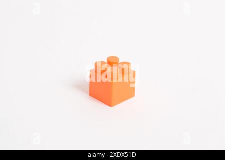 Orange Plastic toy blocks isolated on white background. Building Blocks Stock Photo