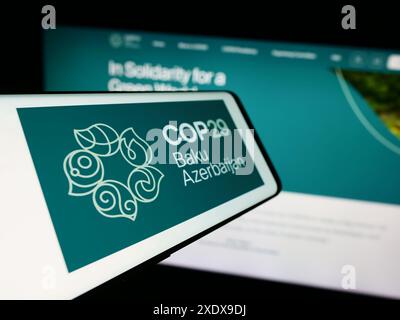 Cellphone with logo of United Nations Climate Change Conference 2024 COP29 in front of website. Focus on left of phone display. Stock Photo