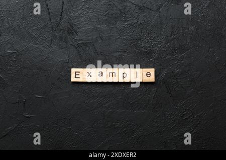 example word written on wood block. example text on table, concept. Stock Photo