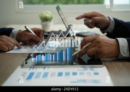 Business people working growth graph business analyzing on laptops in an office investment money Stock Photo