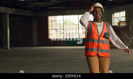 Confident Black Woman Engineer Wearing Safety Gear in a Construction Site Stock Photo