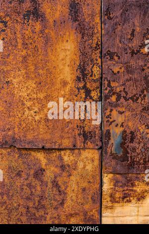Rusted flat composite nailed metal sheets surface background and texture. Stock Photo