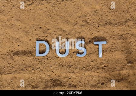 The word dust on dusty road surface in flat lay perspective Stock Photo