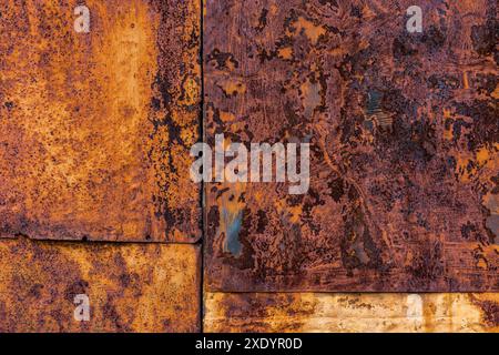 Rusted flat composite nailed metal sheets surface background and texture. Stock Photo