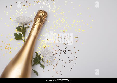 Flat lay composition of Champagne bottle and confetti Stock Photo