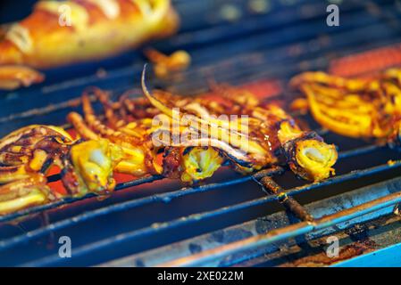 Close up grilling squid tentacles on charcoal stove, only squid tentacles on charcoal stove. Stock Photo