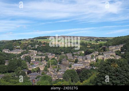 View of hebden bridge showing streets and the town centre surrounded by pennine countryside in summer sunlight Stock Photo