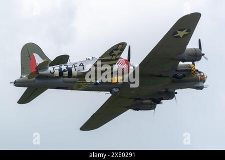 Republic P-47 Thunderbolt fighter plane flying alongside Boeing B-17 Flying Fortress named Sally B at the Sywell Airshow 2024 in Northamptonshire, UK. Stock Photo