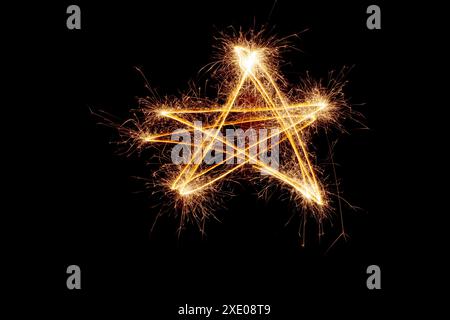 Sparkler firework light with star shape isolated on black background. Stock Photo