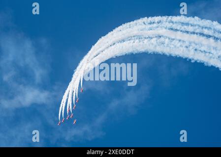 RAF Red Arrows display team displaying at the Sywell Airshow 2024 in Northamptonshire, UK. Formation flying down from the top of a loop in blue sky Stock Photo