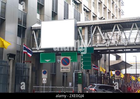 Big blank billboard white LED screen vertical outstanding in the city on pathway side the road traffic with car for display advertisement text templat Stock Photo