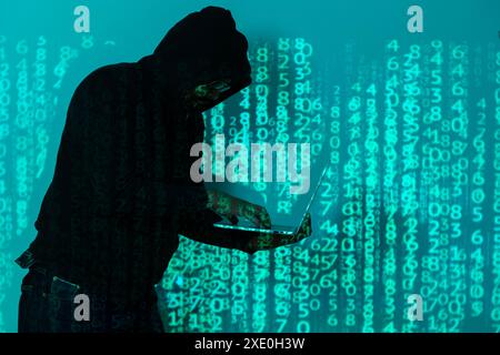 Internet crime concept. Hacker working on code on dark digital background with round digital interface. Hand typing data on keyboard seen on computer Stock Photo