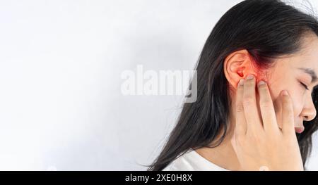 Young woman with sore ear, suffering from otitis, black and white panorama with red accent, free space. Unhealthy lady suffering from strong earache, Stock Photo