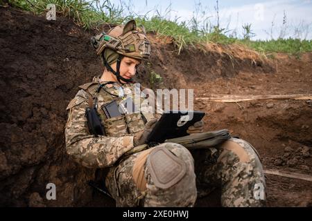 A female platoon commander (codename 'Shylka') at a position used by a Ukrainian FPV drone unit from the 92nd Brigade, known as 'Achilles', about 10 kilometres from the Russian border in Kharkiv Oblast, Ukraine. First Person View (FPV) drones have changed the nature of warfare in Ukraine, with both Ukrainian and Russian forces coming to rely on these drones, which are armed with explosives and remotely controlled by a pilot wearing a headset. Stock Photo