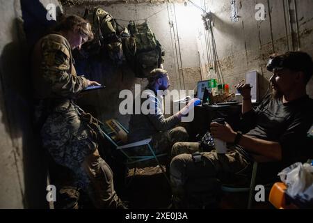 June 12, 2024, Kharkiv, Ukraine: An FPV drone unit from the 92nd Brigade, known as ''Achilles'', operates inside a bunker about 10 kilometers from the Russian border in Kharkiv Oblast, Ukraine. First Person View (FPV) drones have changed the nature of warfare in Ukraine, with both Ukrainian and Russian forces coming to rely on these drones, which are armed with explosives and remotely controlled by a pilot wearing a headset. (Credit Image: © Laurel Chor/SOPA Images via ZUMA Press Wire) EDITORIAL USAGE ONLY! Not for Commercial USAGE! Stock Photo