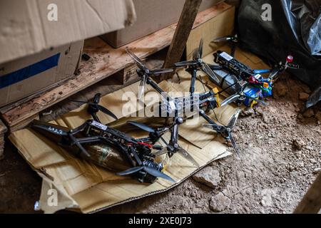 FPV drones with explosives attached to them are seen inside a bunker used by the 92nd Brigade, known as the "Achilles" Brigade, at a position about 10 kilometers from the Russian border in Kharkiv Oblast, Ukraine. First Person View (FPV) drones have changed the nature of warfare in Ukraine, with both Ukrainian and Russian forces coming to rely on these drones, which are armed with explosives and remotely controlled by a pilot wearing a headset. (Photo by Laurel Chor / SOPA Images/Sipa USA) Stock Photo