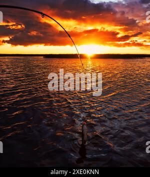 Fishing at sunset Stock Photo