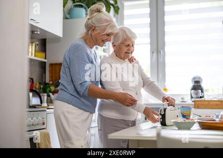 Happy senior woman with her adult daughter at home Stock Photo
