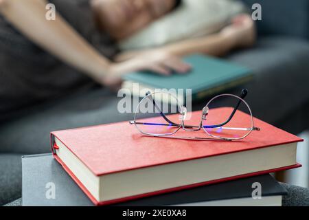 A young woman fell asleep while reading a book Stock Photo