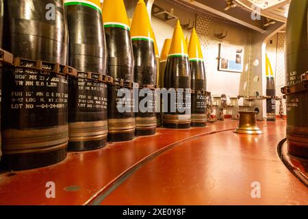 Inert ammunition for the 16-inch cannons on a World War II battleship line the wall of a turret. Stock Photo