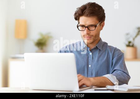 Man Working on Laptop in Office Stock Photo