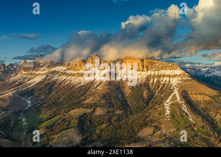 Rocky snow mountains at sunset aerial Stock Photo