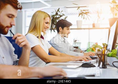 Diverse young people using office computers at coworking Stock Photo