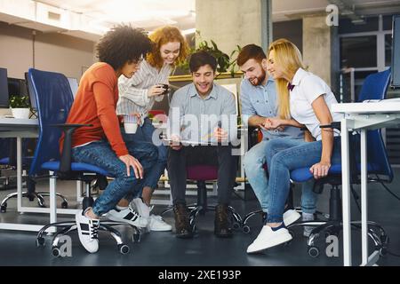 Young creative team discussing new project in coworking space Stock Photo
