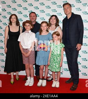 LONDON, UK. 25th June, 2024. Pupils from St Luke's CE Primary School, Rugby with the Best Film - 11 and Under award for "Dyslexia and Me" with award presenters Thomas McKenzie (L) and David Morrissey at the Into Film Awards 2024 at the Odeon Luxe Leicester Square on June 25, 2024 in London, England. Credit: See Li/Picture Capital/Alamy Live News Stock Photo