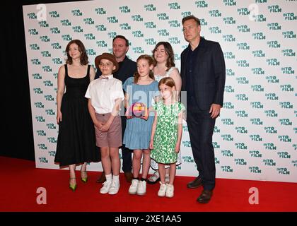 LONDON, UK. 25th June, 2024. Pupils from St Luke's CE Primary School, Rugby with the Best Film - 11 and Under award for "Dyslexia and Me" with award presenters Thomas McKenzie (L) and David Morrissey at the Into Film Awards 2024 at the Odeon Luxe Leicester Square on June 25, 2024 in London, England. Credit: See Li/Picture Capital/Alamy Live News Stock Photo