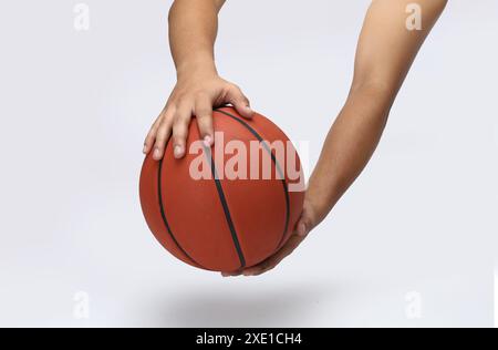 basketball hold with the hand on white background Stock Photo