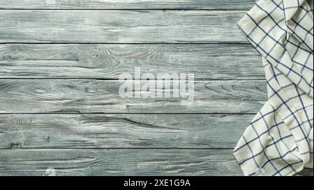 Gray wooden table with kitchen napkin, flat lay Stock Photo
