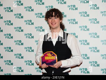 LONDON, UK. 25th June, 2024. Ben Mullan, aged 18, (C) with the Ones to Watch award with award presenters Jayden Revri (L) and Zawe Ashton at the Into Film Awards 2024 at the Odeon Luxe Leicester Square on June 25, 2024 in London, England. Credit: See Li/Picture Capital/Alamy Live News Stock Photo