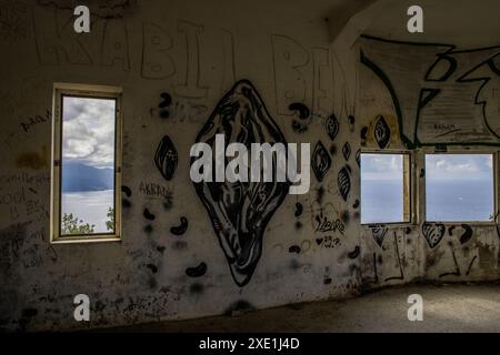 Inside bunker on Punta Mesco in Monterosso. The Ligurian Sea visible through windows. Walls tagged with graffiti. Stock Photo