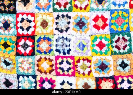 Multi colored blanket in wool, square geometric background, retro decorative pattern Stock Photo