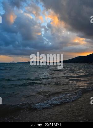 Stormy sunset over sea shore Stock Photo