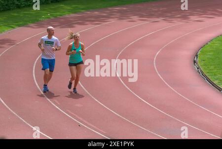 2024-06-07, Brussels, Belgium. Couple of athletes running on a track. Stock Photo
