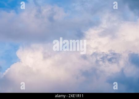 Blue sky background with white and pink clouds at sunset Stock Photo