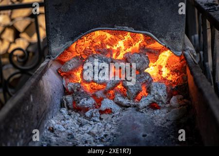 Burning coals in a metal grill for frying meat and vegetables. Stock Photo