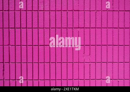 Background from a wall made of rectangular pink mosaic tiles Stock Photo
