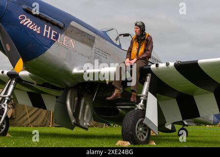 Pilot re-enactor sitting on a North American P-51 Mustang at the Sywell Airshow 2024 in Northamptonshire, UK. Named Miss Helen Stock Photo