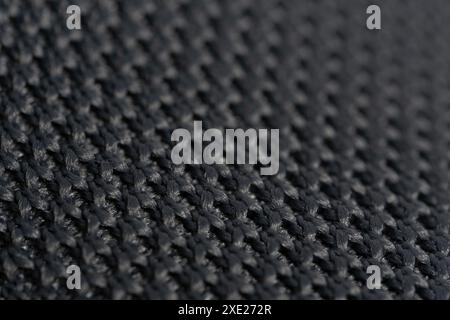 Black knitted fabric as a background. Close-up. Macro Stock Photo