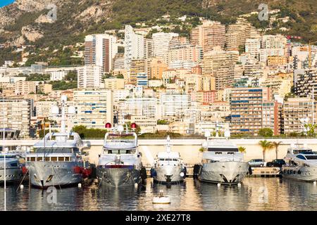 Monte Carlo, Monaco - Port Hercule with luxury yachts,  boats, and scenery skyline Stock Photo