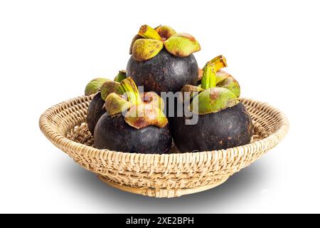 Pile of ripe mangosteen in bamboo basket isolated on white background. Stock Photo
